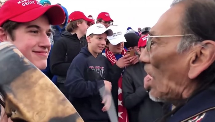 High school student Nick Sandmann facing Native American Activist Nathan Philips on the National Mall